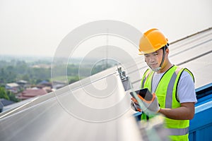 Young electrical engineer Work in a photovoltaic power plant Checking solar panel quality And control the electricity in the