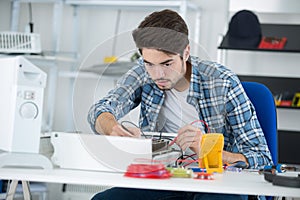 young electrician measuring earth resistance