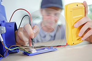 Young electrician testing flow