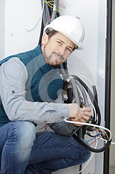 young electrician worker with cables