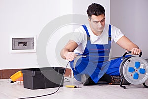 The young electrician working on socket at home