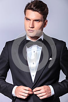 Young elegant business closing his tuxedo