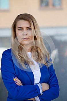 Young elegant business woman in blue jacket.