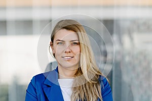 Young elegant business woman in blue jacket.