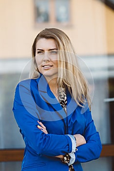 Young elegant business woman in blue jacket.