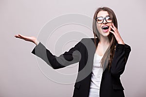 Young elegant business woman pointing invisible product