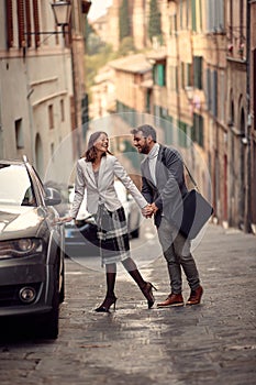 A young elegant couple in love is having a good time while walking the city. Walk, rain, city, relationship