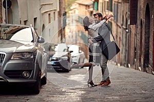 A young elegant couple in love is in hug while walking the city. Walk, rain, city, relationship