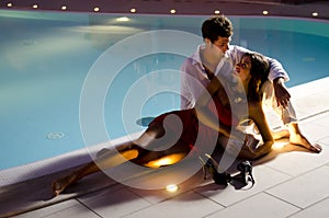 Young elegant couple near the pool