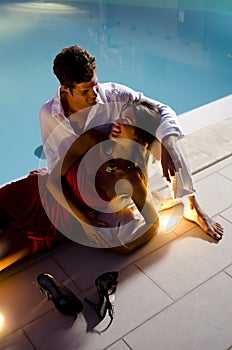 Young elegant couple near the pool