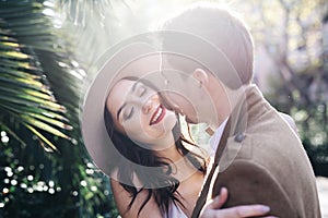 Young elegant fashion couple smiling in park