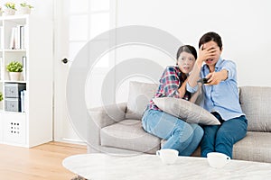 Young elegant female friends watching tv together