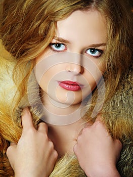 Young elegant girl with fur collar