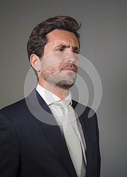 Young elegant and handsome businessman in suit and tie posing for company corporate portrait relaxed and confident isolated on wh