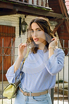 young elegant latin woman outside home standing posing looking at the camera before going to work