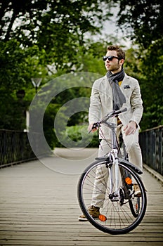 Young and elegant man with a bicicle photo