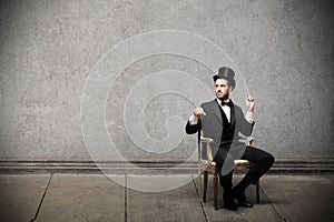 Young elegant man sitting on a chair