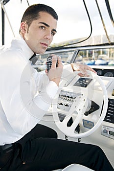 Young elegant man at yatch control photo