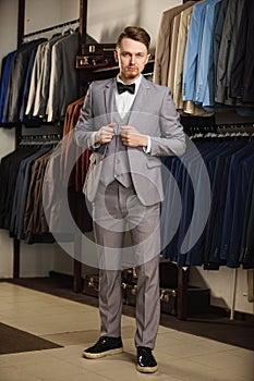 Young elegant model wearing suit and looking in the camera