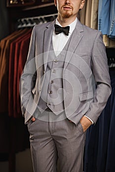 Young elegant model wearing suit and looking in the camera