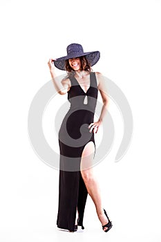 Young elegant woman in black dress with hat on