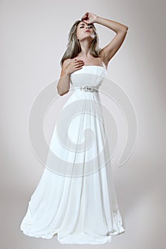 Young elegant woman in white trendy dress