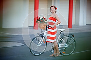 Young elegantly dressed woman with bicycle and a