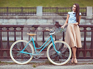 Young elegantly dressed woman with bicycle, summer and lifestyle