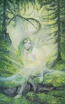 Young elf fairy with green hair and dragonfly wings in a green forest