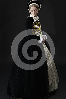 A young Elizabethan woman in a black velvet dress