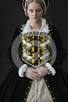 A young Elizabethan woman in a black velvet dress