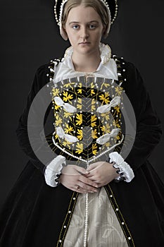 A young Elizabethan woman in a black velvet dress photo