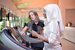 Young Emirati arab muslim women wroking out in a Gym