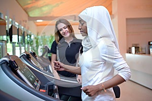 Young Emirati arab muslim women wroking out in a Gym