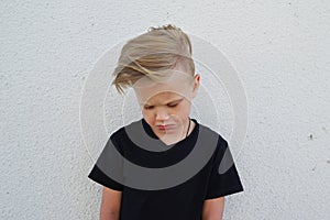 Young emotional boy on bright background