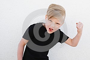 Young emotional boy on bright background