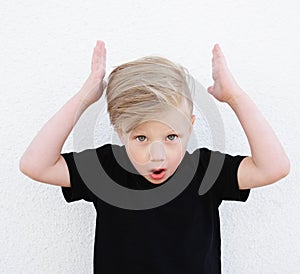 Young emotional boy on bright background