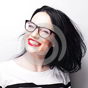 Young emotional brunette woman wearing glasses