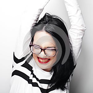 Young emotional brunette woman wearing glasses