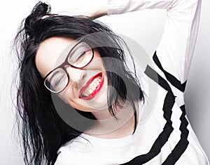 Young emotional brunette woman wearing glasses