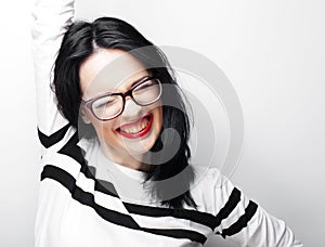 Young emotional brunette woman wearing glasses