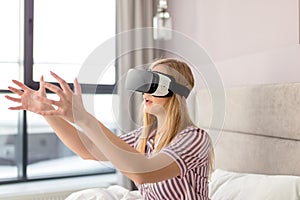 Young emotional girl wearing virtual headset