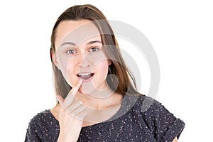 Young emotional woman surprised the finger on the lip