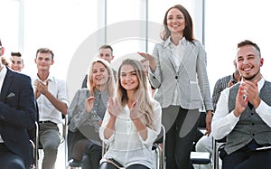 Young employee asks a question at a business seminar.