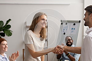 Young employee getting promotion handshaking with boss owner executive manager