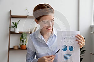 Young employee giving presentation showing financial report looking at charts