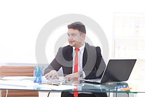 Young employee looking at computer monitor during working day