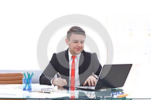 Young employee looking at computer monitor during working day