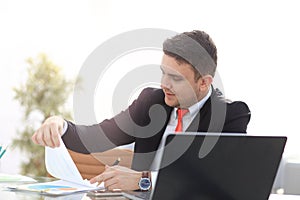 Young employee looking at computer monitor during working day