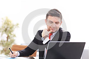 Young employee looking at computer monitor during working day